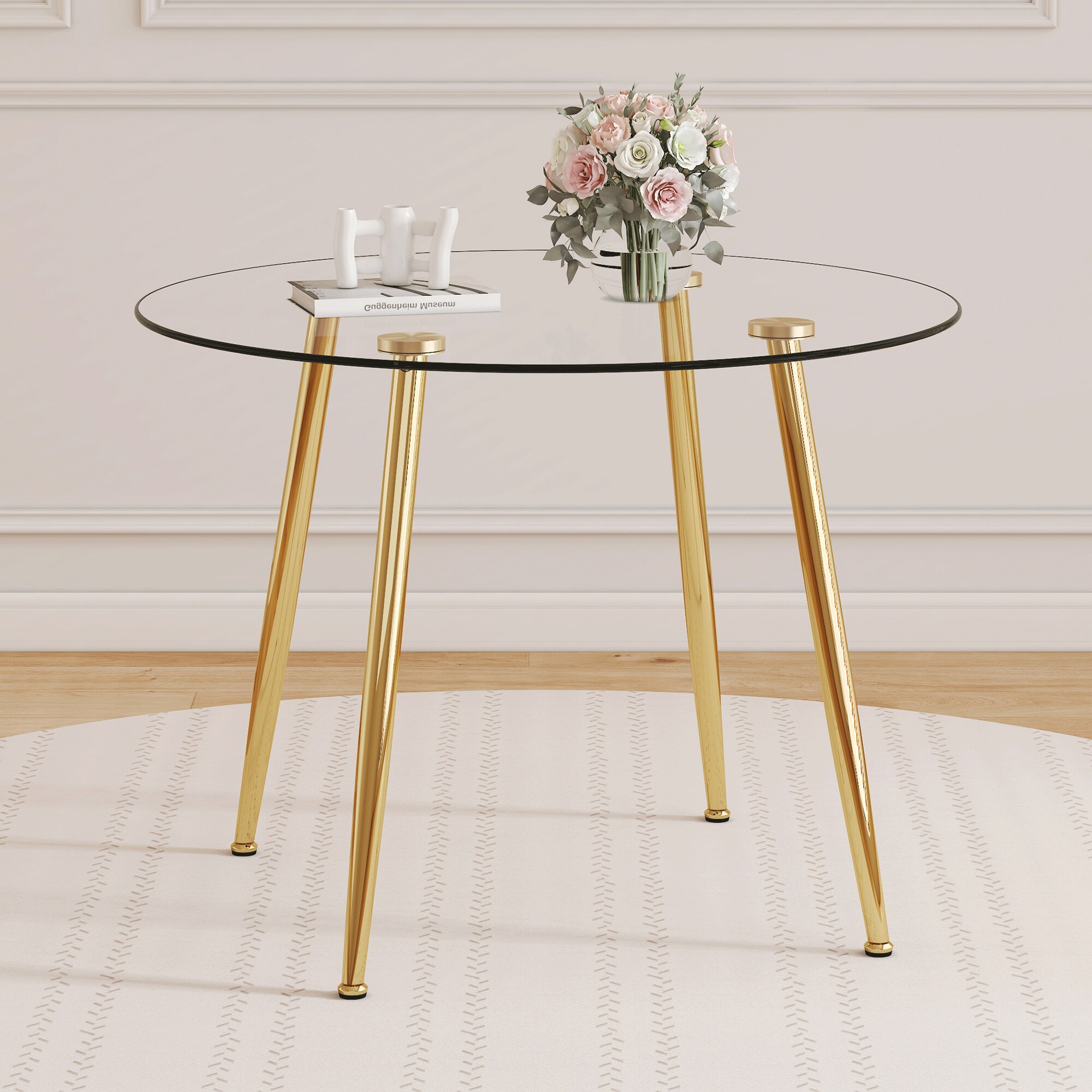 39.7-inch diameter circular dining table: transparent glass paired with golden table legs, showcasing an elegant style and fashionable restaurant furniture. 39.7-inch diameter circular dining table: transparent glass paired with golden table legs, showcasing an elegant style and fashionable restaurant furniture.